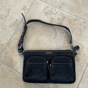 Black Coach belt bag with multiple zippers and compartments